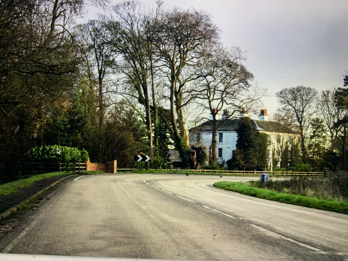 Charming approach to Scarthingmoor House Farm with tree-lined driveway and distinctive white farmhouse nestled in rural Nottinghamshire countryside